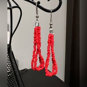 Coral color seed bead earrings.